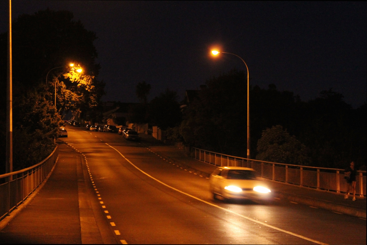 A can speeding on an empty road at night